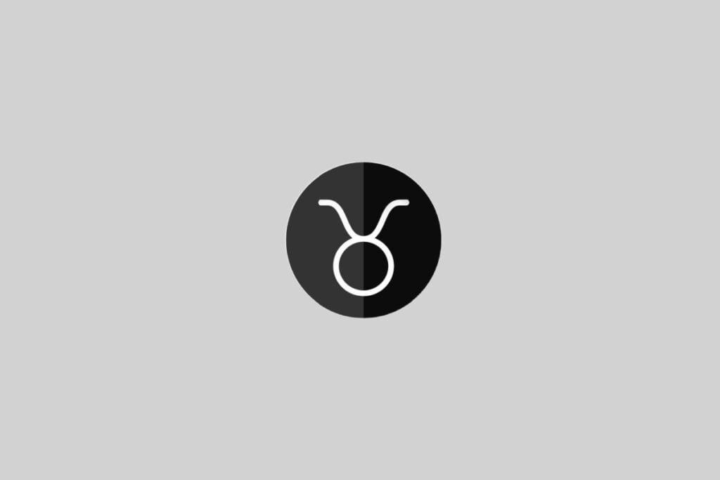 Ilustração do signo de Touro, contendo um círculo com dois traços curvos no topo representando os chifres, em círculo bicolor (preto e branco) em fundo cinza