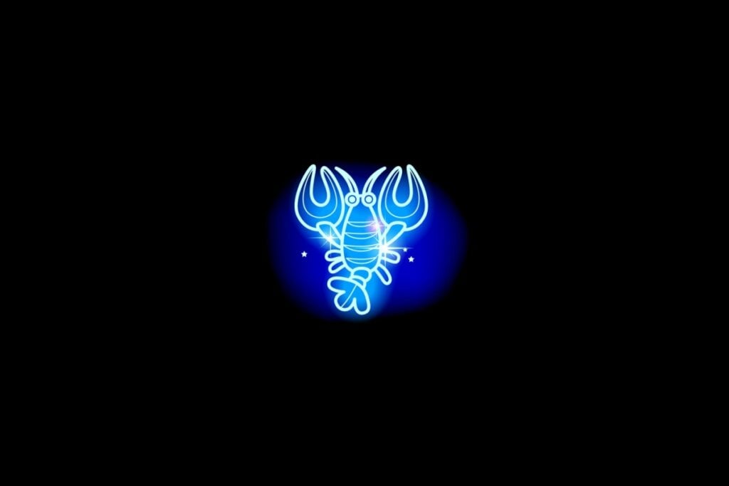 Ilustração do signo de câncer em azul sobre um fundo preto