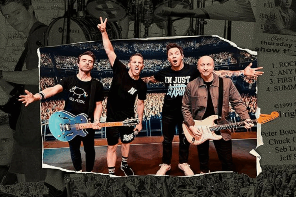Imagem de 4 homens fazendo pose para foto após o show, com o público ao fundo