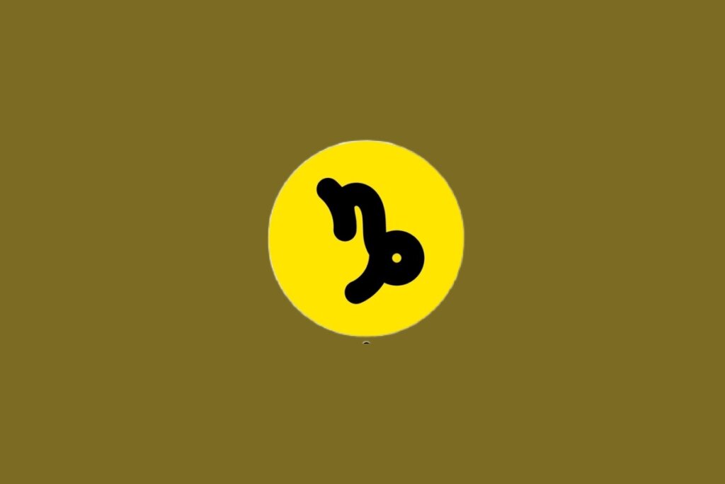 Ilustração do signo de Capricórnio, contendo glifo preto curvo lembrando “n” com laçada final, em círculo amarelo
