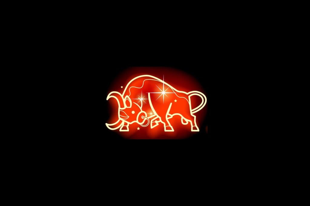 Ilustração em vermelho neon do signo de Touro em um fundo preto 