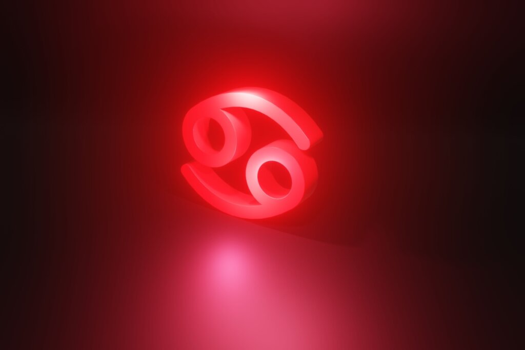 Ilustração em vermelho do símbolo do signo de Câncer em fundo vermelho