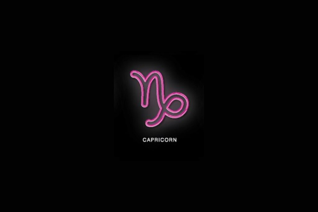 Ilustração rosa do símbolo de capricórnio em fundo preto sobre o nome branco do signo