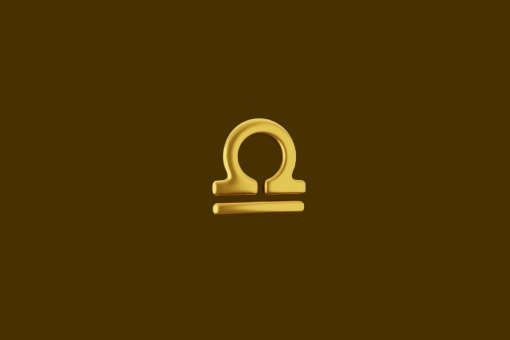 Ilustração dourada do símbolo do signo de libra em um fundo marrom