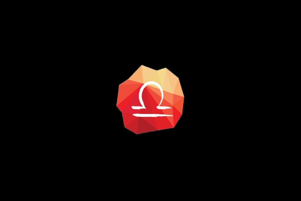 Ilustração do símbolo do signo de libra em um cristal vermelho e laranja sobre o fundo preto