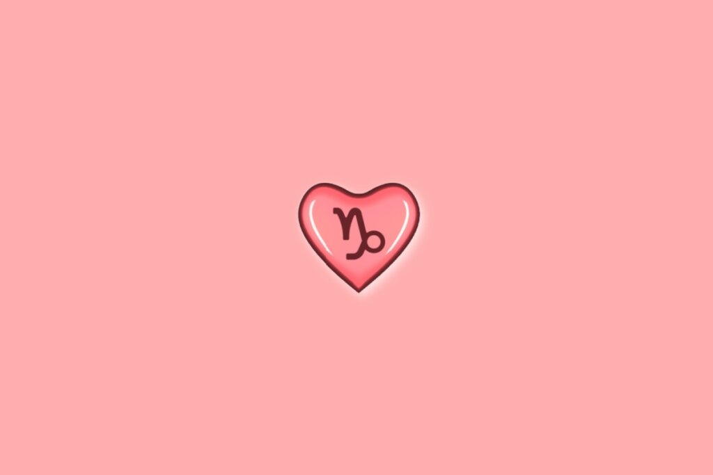 Coração em fundo vermelho-claro com o símbolo do signo de capricórnio dentro