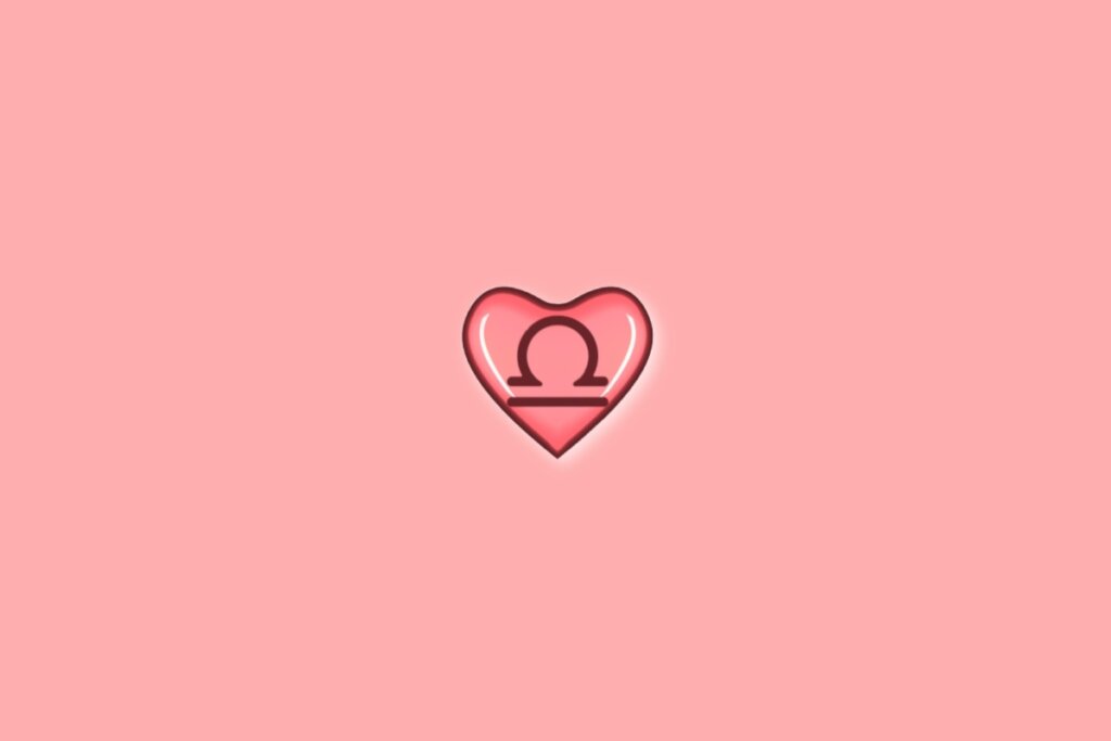 Coração em fundo vermelho-claro com o símbolo do signo de libra dentro