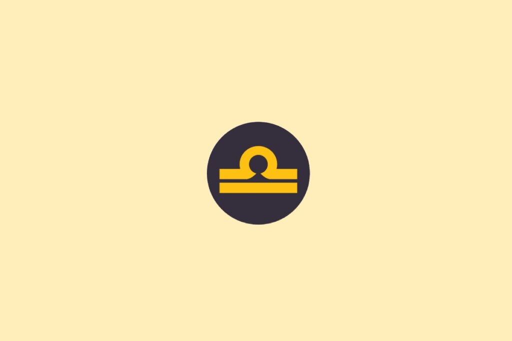 Um símbolo do signo de Libra em amarelo, dentro de um círculo escuro, sobre um fundo claro bege