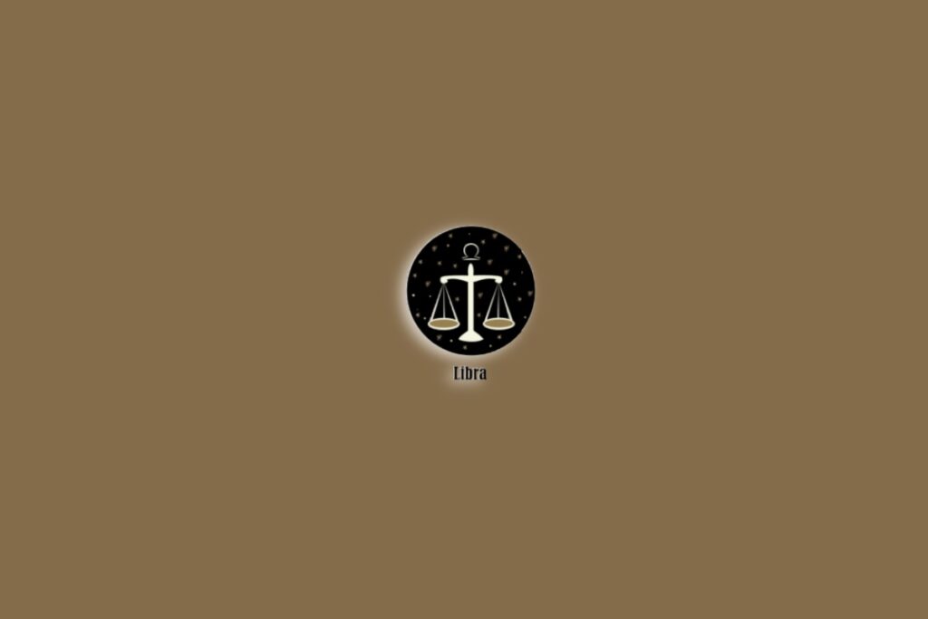 Símbolo do signo de Libra com a ilustração de uma balança sobre um fundo marrom