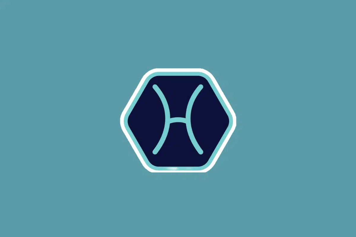 Ilustração minimalista do símbolo do signo de peixes em tom azul-claro, centralizada dentro de um hexágono azul-escuro com borda branca e azul. O fundo da imagem é em um tom sólido de azul-turquesa