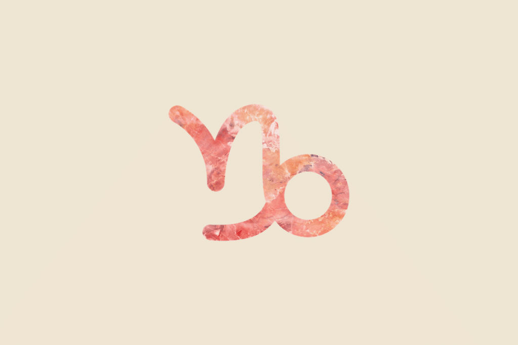 Ilustração do signo Capricórnio, contendo o símbolo do signo com textura de mármore em tons de coral e rosa, formado por uma letra V com a ponta direita terminando em um laço, lembrando a cauda de uma cabra-peixe, em fundo bege.